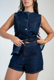 Women's sleeveless denim vest and high-waisted denim shorts set with gold button details.